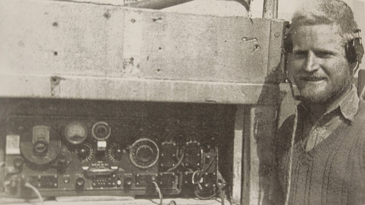 An LRDG wireless operator at his set, wearing headphones