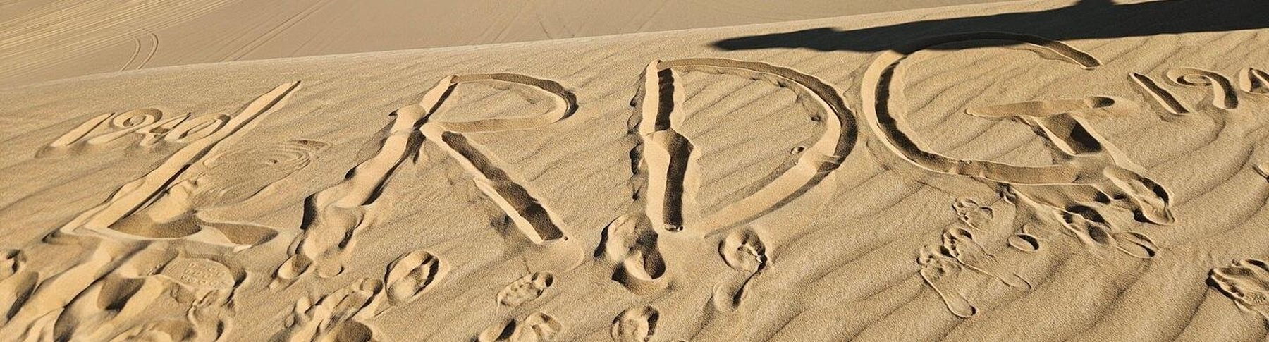 1940 LRDG 1945 written in the sand of a desert dune