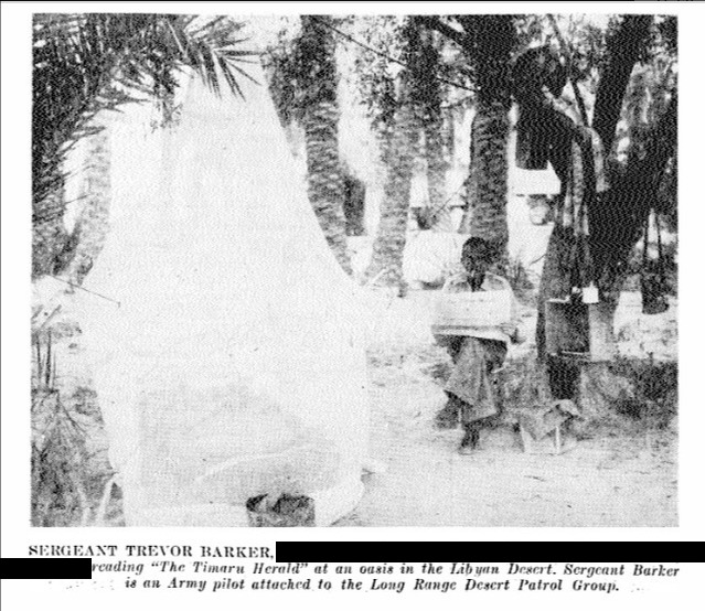 Sergeant Trevor Barker reading the Timaru Herald at an oasis in the Libyan Desert